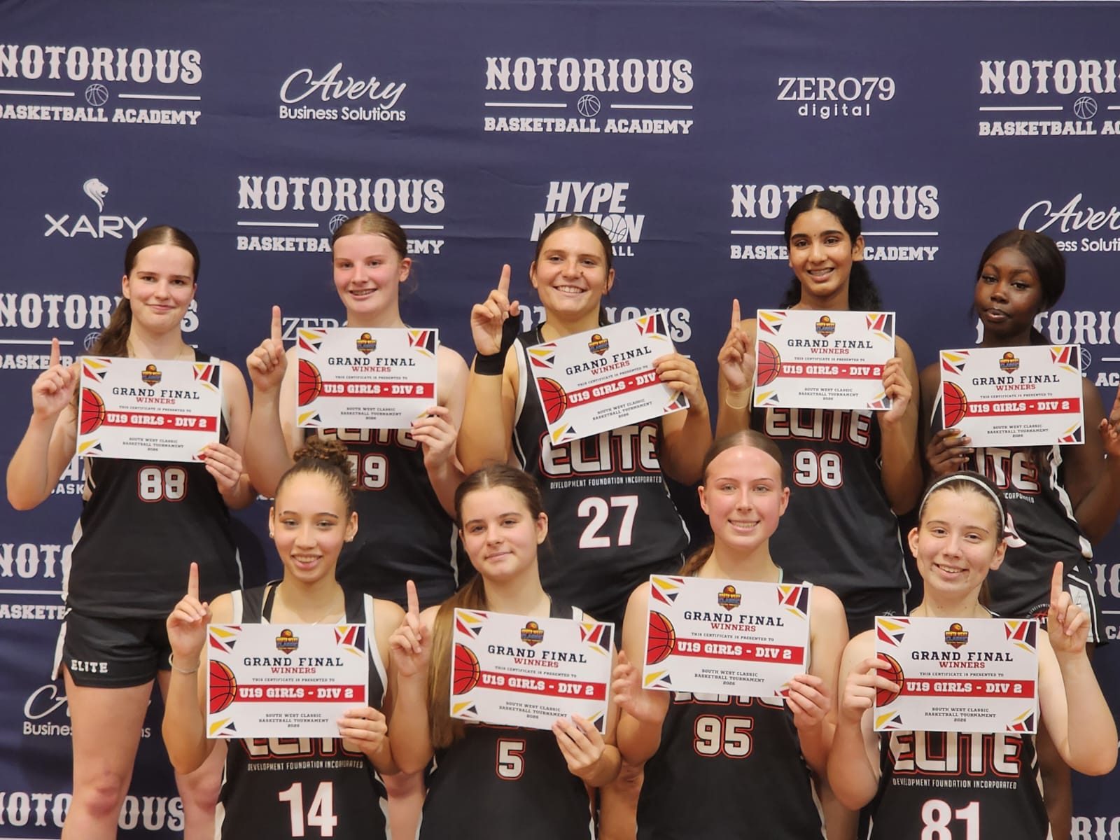 El!te players hold up Grand Final Winners certificates for U19 Girls Division 2 at the South West Classic 2026